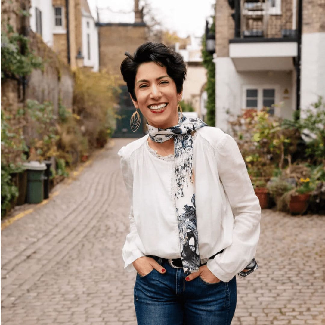 A lady in a white shirt smiling at the camera 